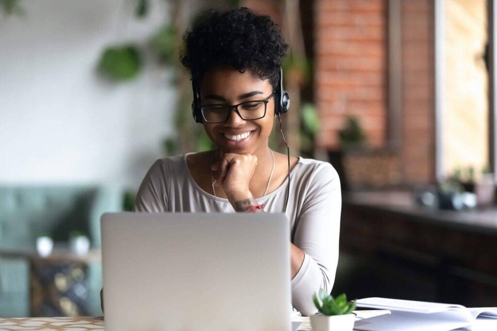 woman on a laptop smiling