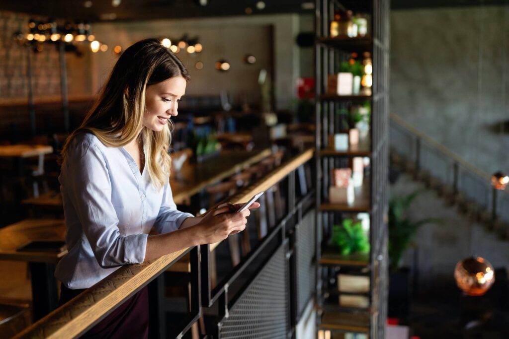 Beautiful young woman using mobile phone. Business, technology, social network concept