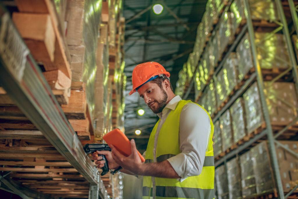 man in high vis and hard hat in warehouse