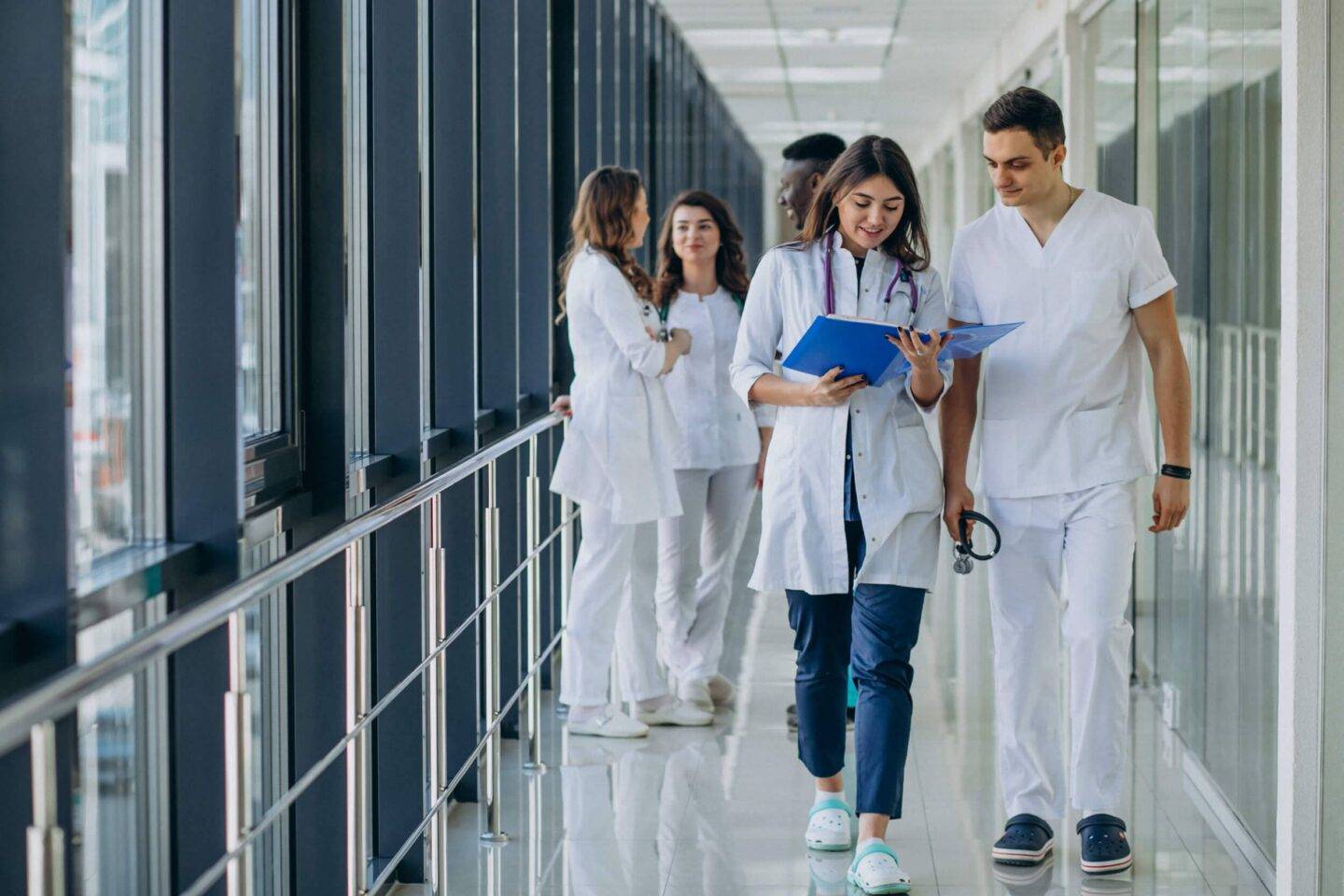 people walking in corridor of a hospital