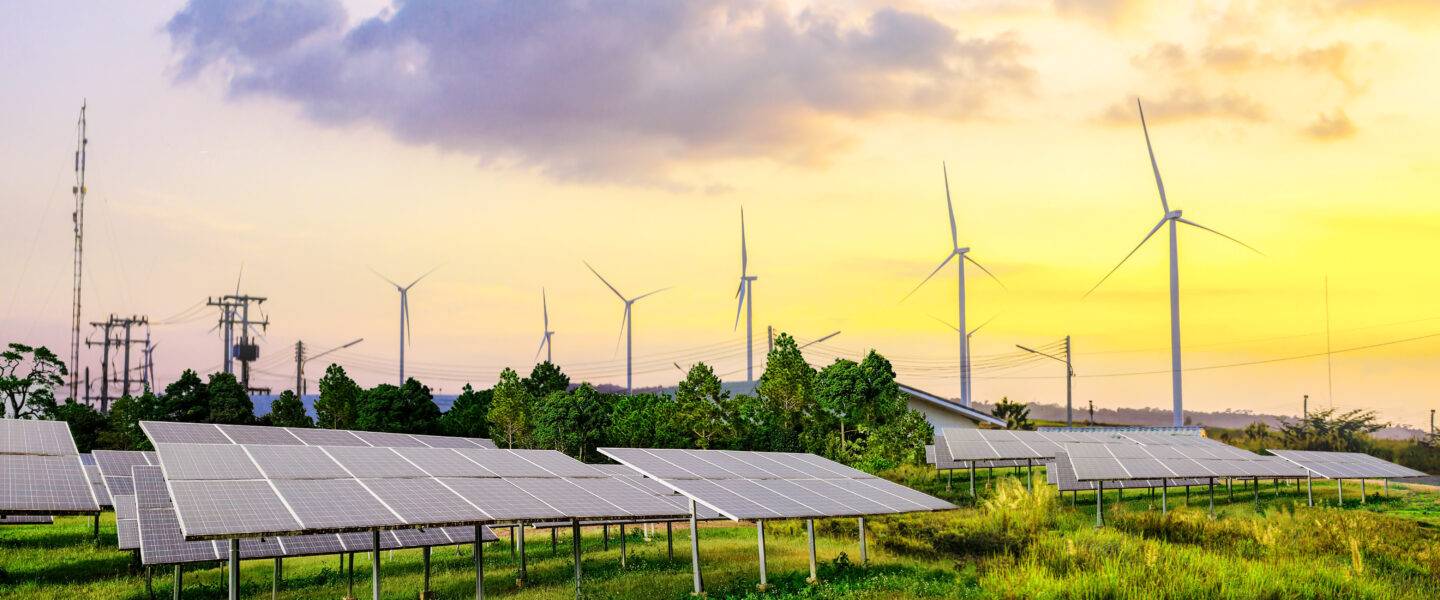 Solar cell panels and wind turbines in sunset sky for alternativ